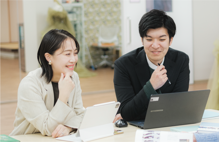 男性教師と女性教師がPCで打ち合わせする様子の写真